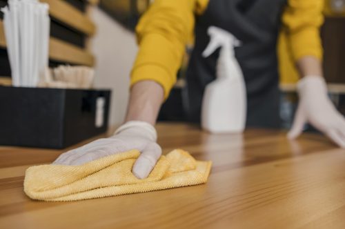 front-view-of-barista-cleaning-table